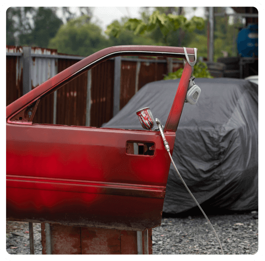 A portrait of a girl under hanging flowers.